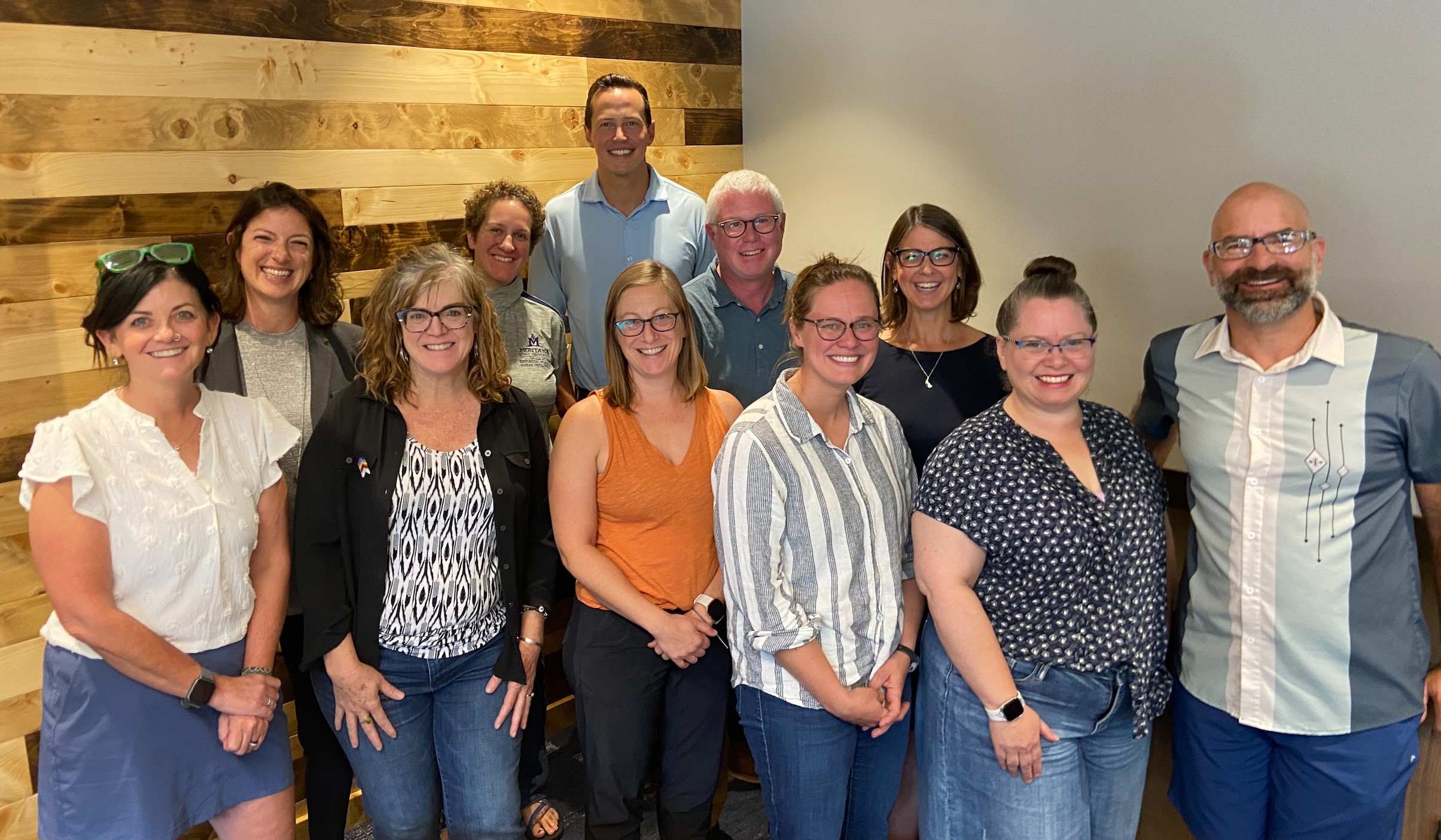 ADP group photo 2023 Image, ten Academic Diversity Partners standing in two rows, smiling and looking at the camera