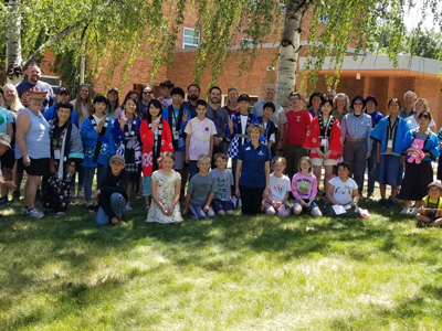 4-H members and Japanese youth posing in front of Hannon Hall at MSU as part of 4-H's international exchange program