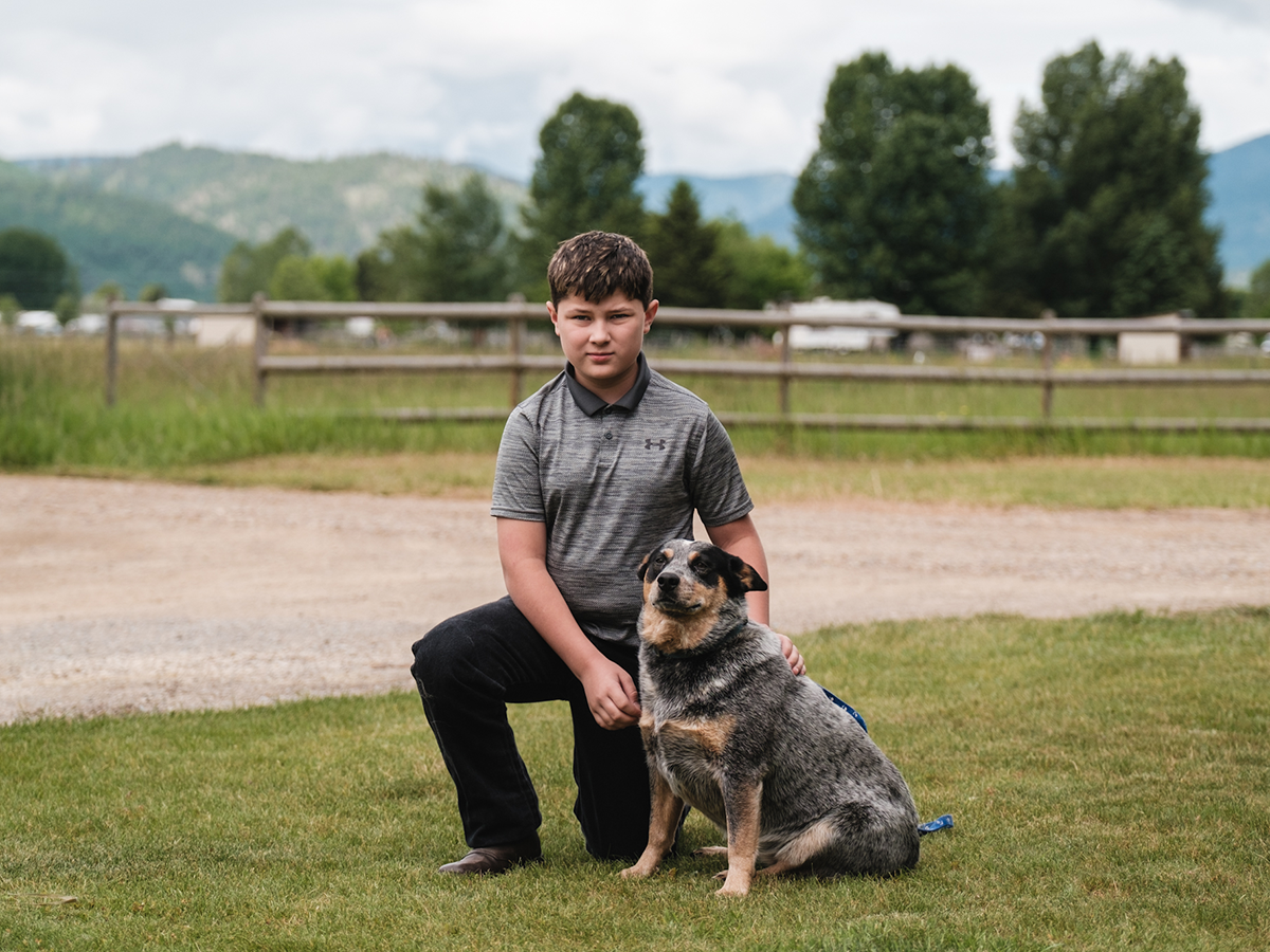 4-H member kneeling next to a dog