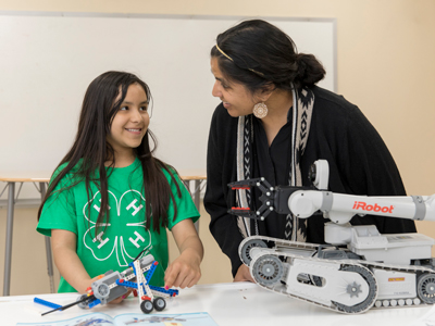 4-H volunteer working with a member on a science project