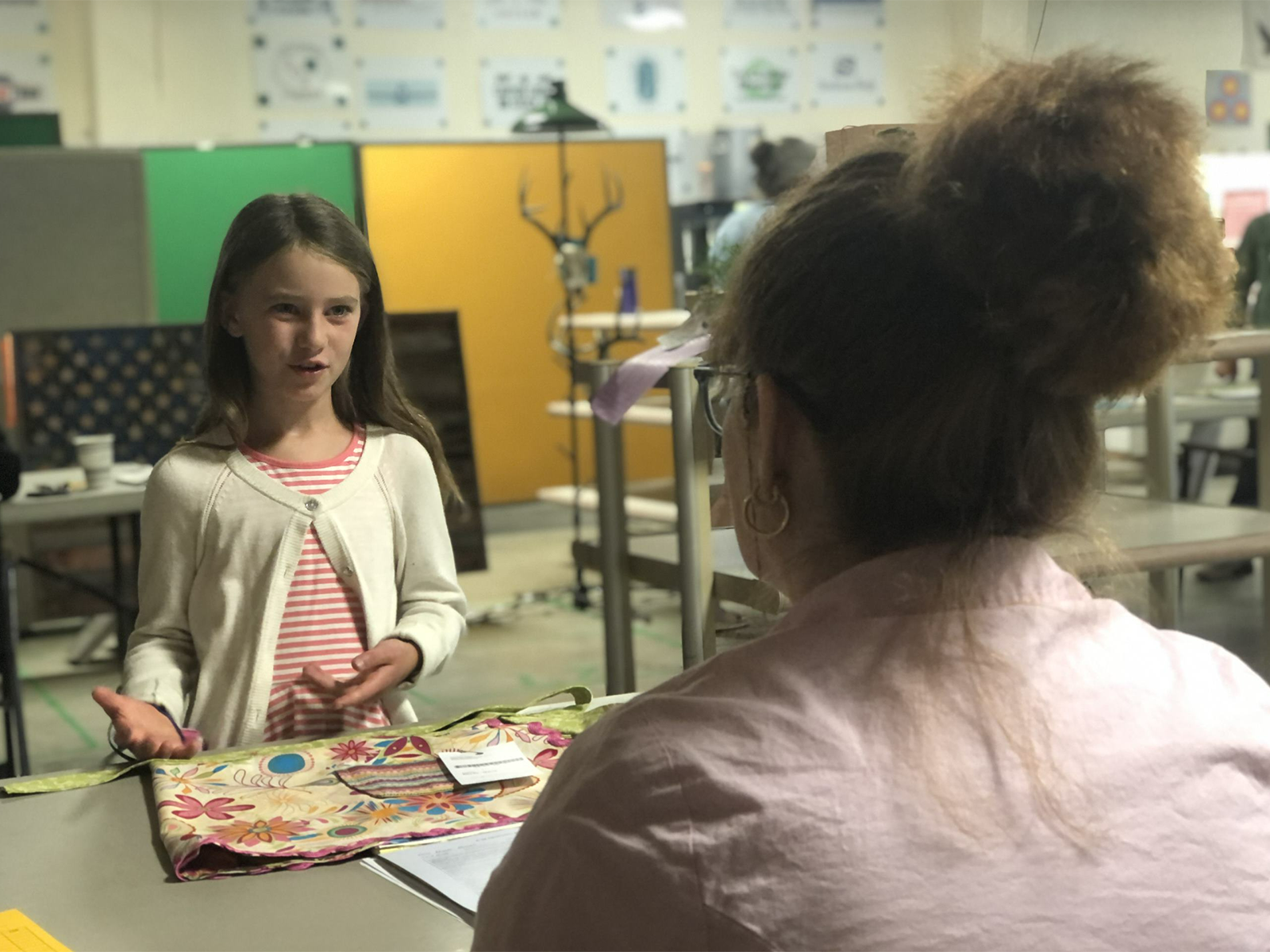4-H member talking to a volunteer