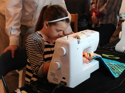 4-H member using a sewing machine