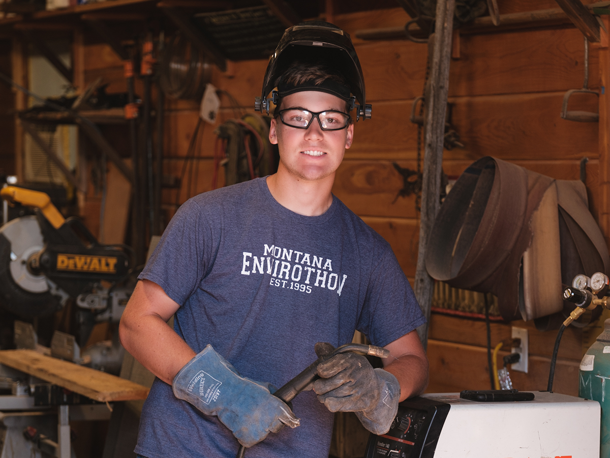 4-H member holding a welding torch