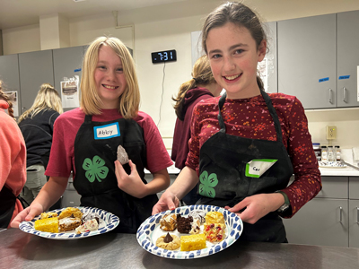 Two 4-H members baking cookies