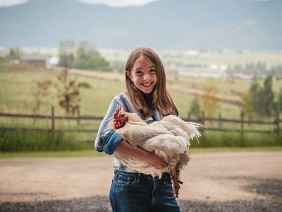 4-H member holding a chicken, one of many common animal projects 4-H members can participate in