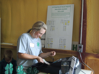 4-H volunteer managing a cash register