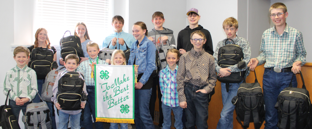 a 4-H club posing with their flag