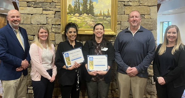 people smiling after recieving an award
