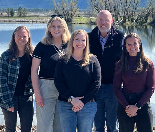 a group of LGC members smiling by a river