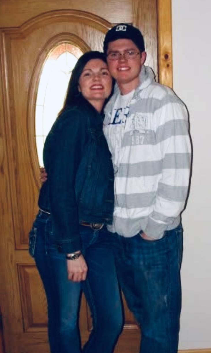 Male student standing next to his mom
