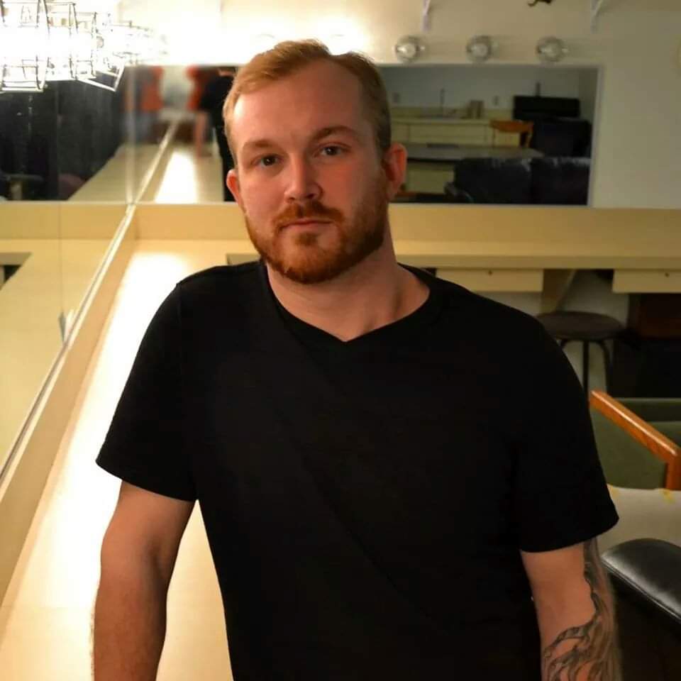 Male student with beard, wearing a black t-shirt